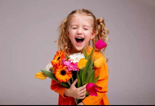 Happy child holding colorful flowers